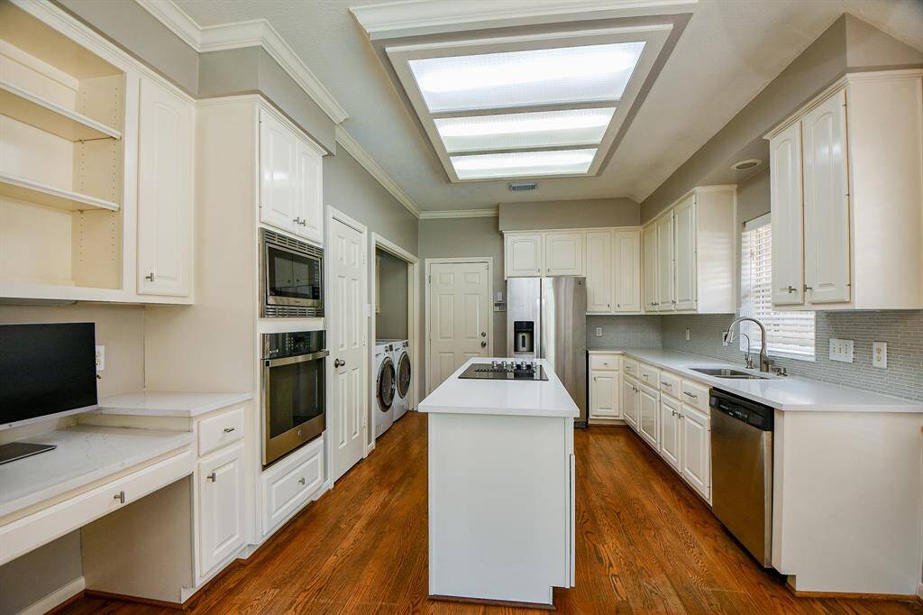 Bright and lights cabinetry with newer quartz c ountertops ready for preparing meals and entertaining.