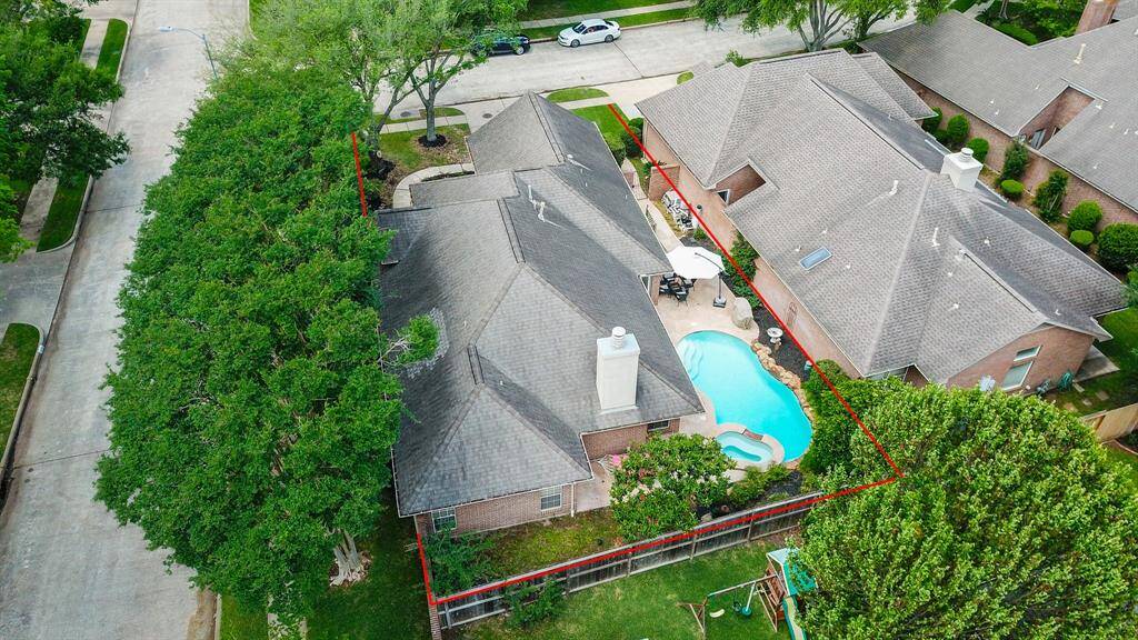 Aerial view of corner lot with pool and spa.