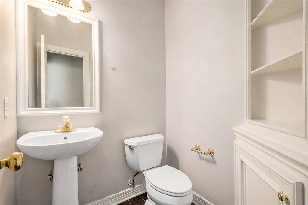 Half bathroom conveniently located next to the kitchen and living room.
