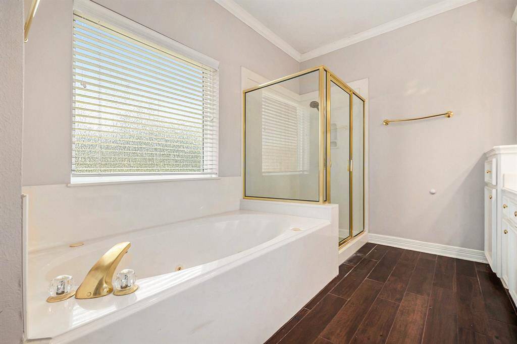 The spa-like primary en suite features a glass standing shower and a soaking tub, offering the ultimate in comfort and relaxation!