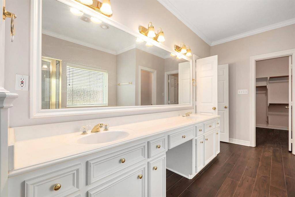 Other amenities to this wonderful primary bathroom are the dual sinks, vanity seating, and a huge walk-in closet.