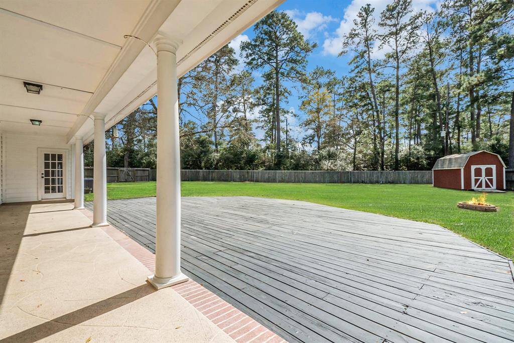 Step outside to a private, tree-lined backyard oasis with a covered patio, deck, and lush green space, perfect for entertaining or unwinding in your own serene escape.