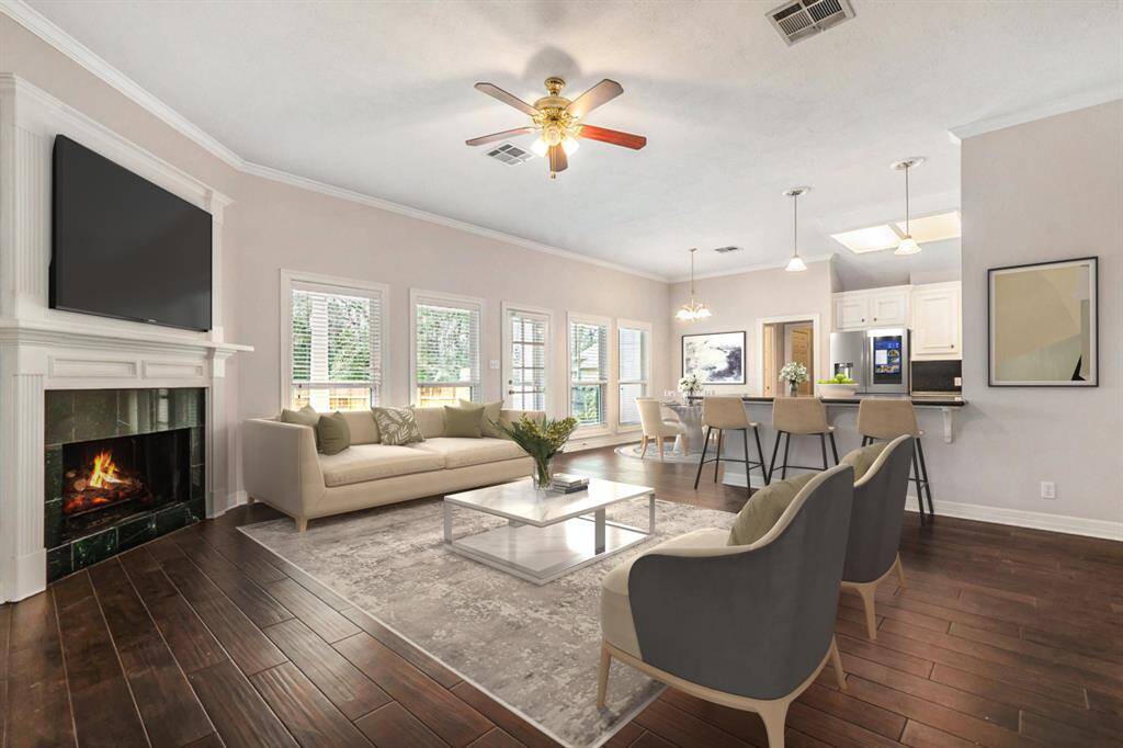 The spacious living room seamlessly flows into the kitchen, creating the perfect open-concept space for entertaining and everyday living! (Virtually Staged)
