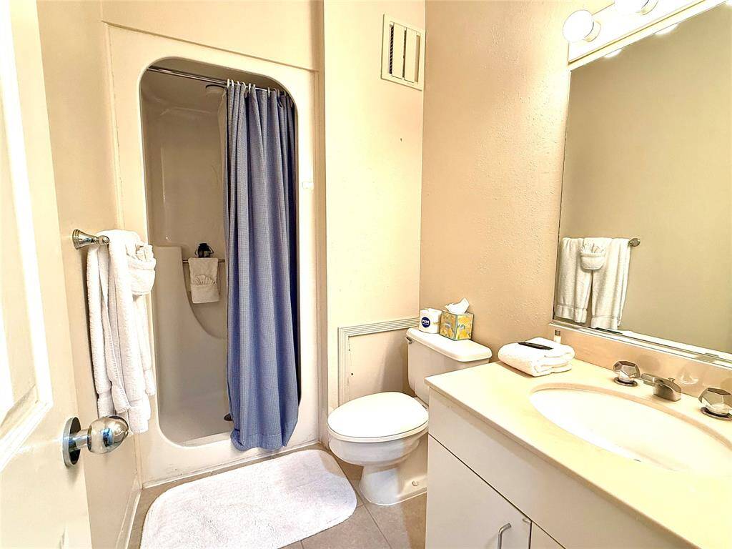 Second bathroom with step in shower.