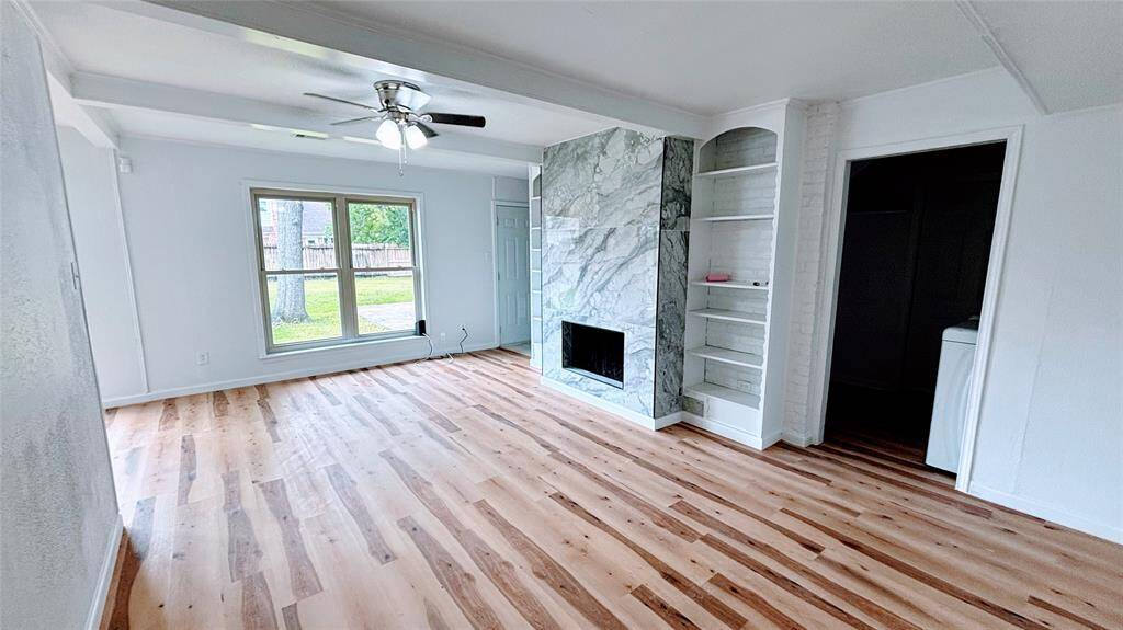 Another view of the open living room space .