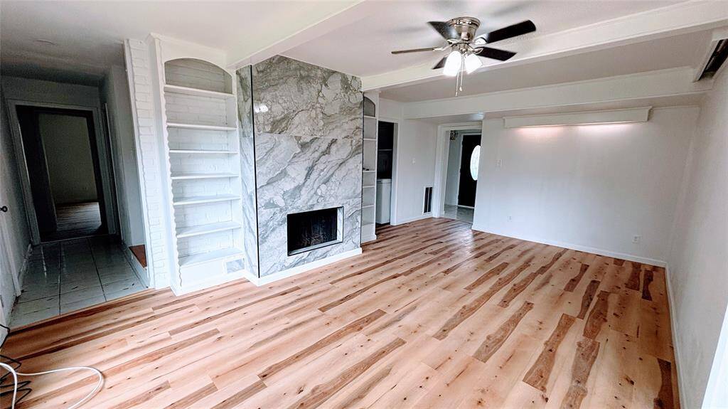 Another view of the open living room space .