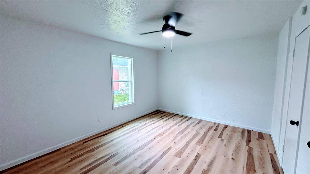 Bright, spacious bedroom # 1 with fresh white walls and light flooring.