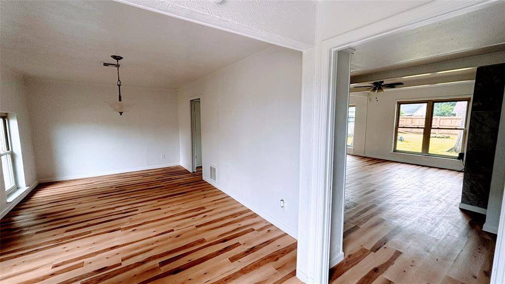Bright and open living space on the left with light flooring.