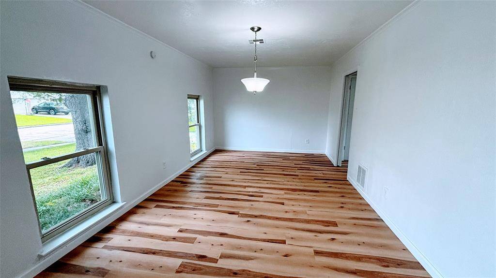Bright and open living space on the left with light flooring.