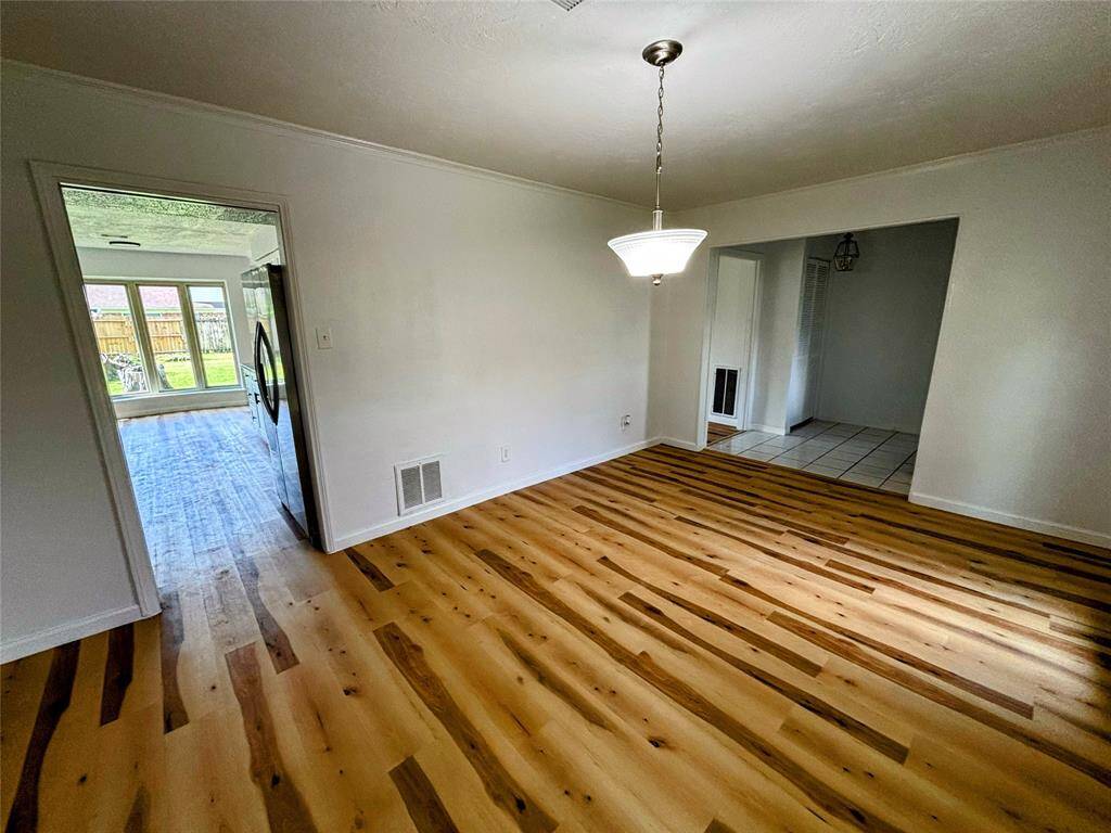 Bright and open living space on the left with light flooring.