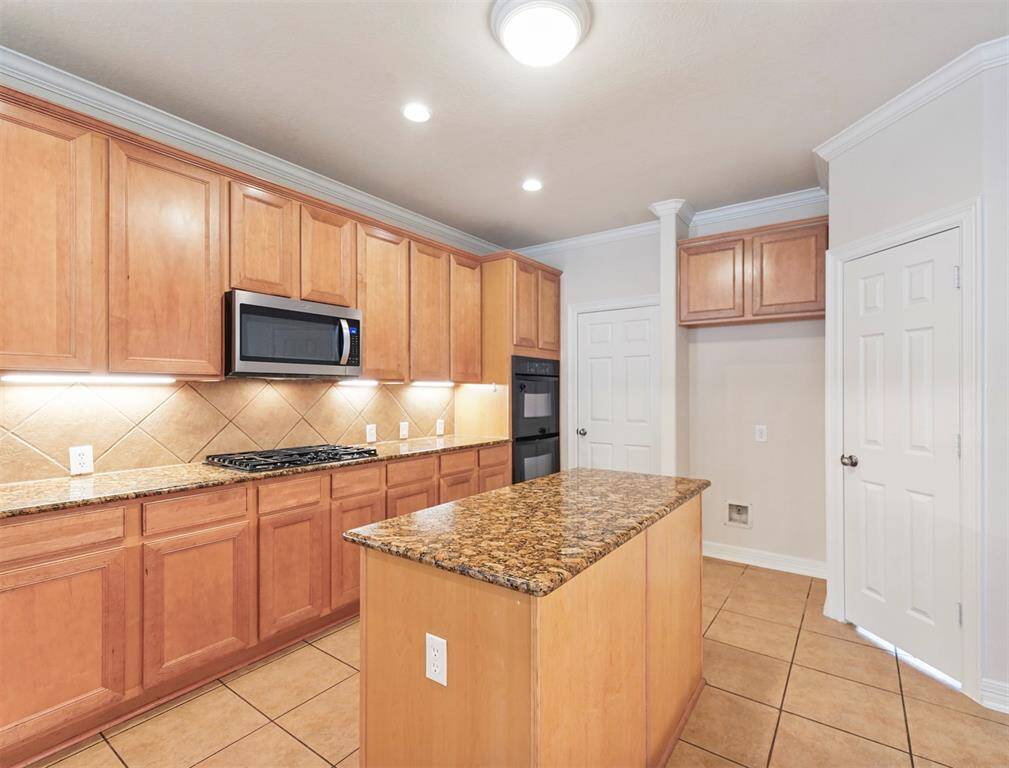 The two doors in the kitchen provide easy access to the spacious laundry room and walk-in pantry.