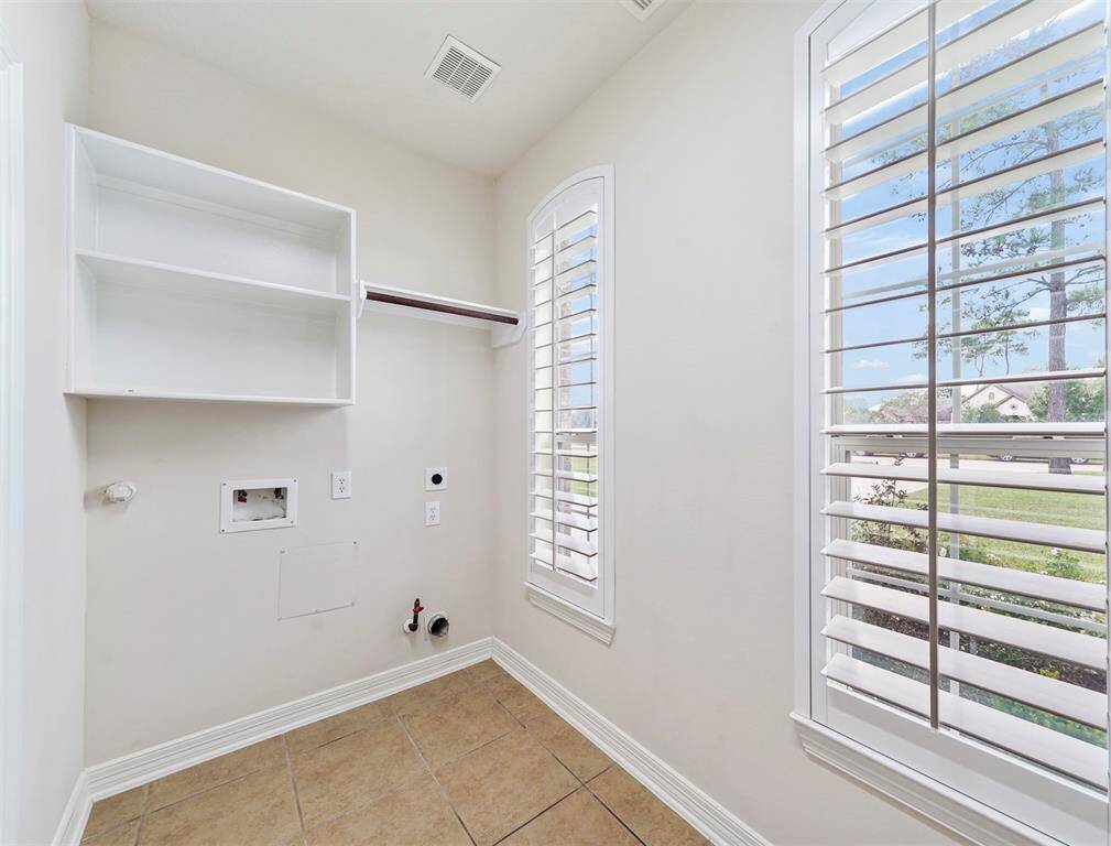 Charming laundry room with built-in shelves!