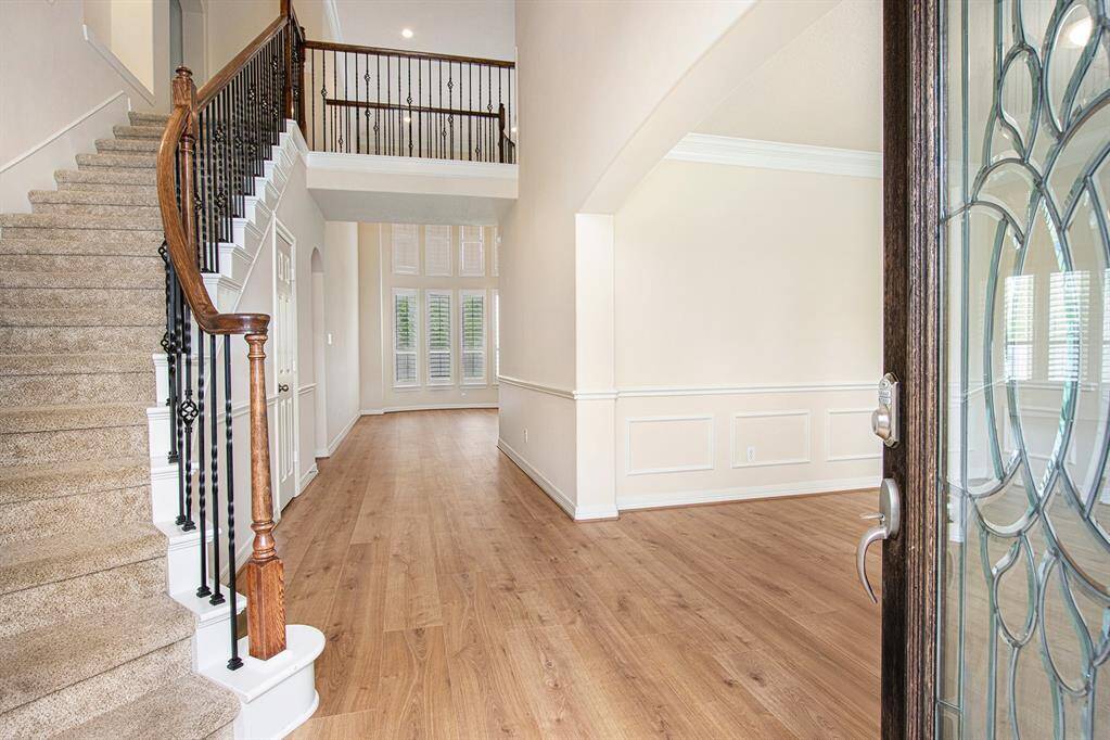 Welcoming entrance with a remarkable wrought ironed staircase and new flooring!
