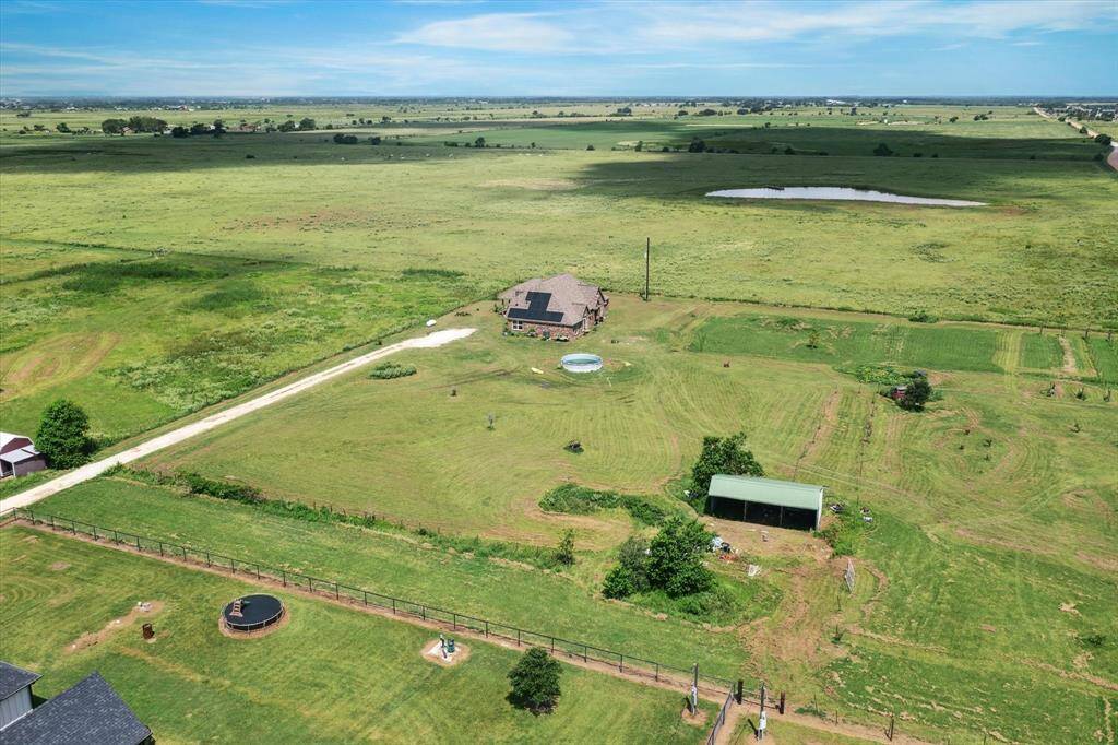 A spacious rural property featuring a large house on 3 acres, horse stall, set against an expansive open landscape.