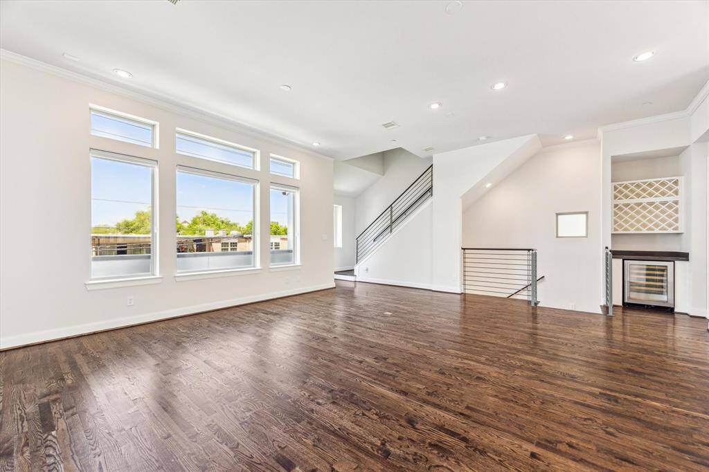 Spacious second-floor open-concept living room and kitchen, offering a perfect blend of functionality and style for family gatherings and entertaining.