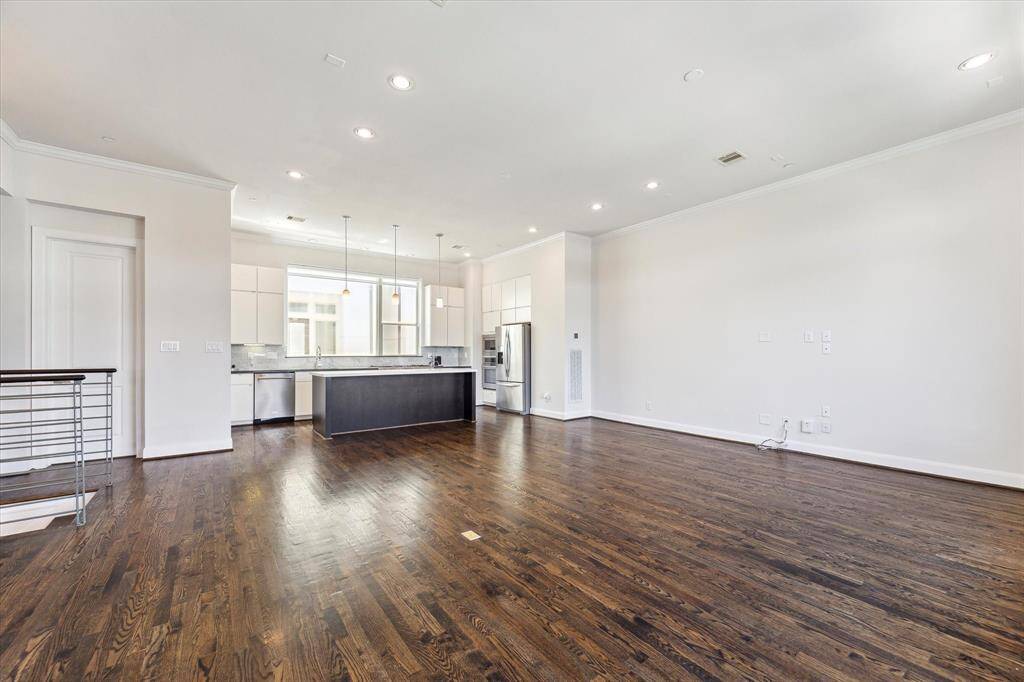 Spacious second-floor open-concept living room and kitchen, offering a perfect blend of functionality and style for family gatherings and entertaining.