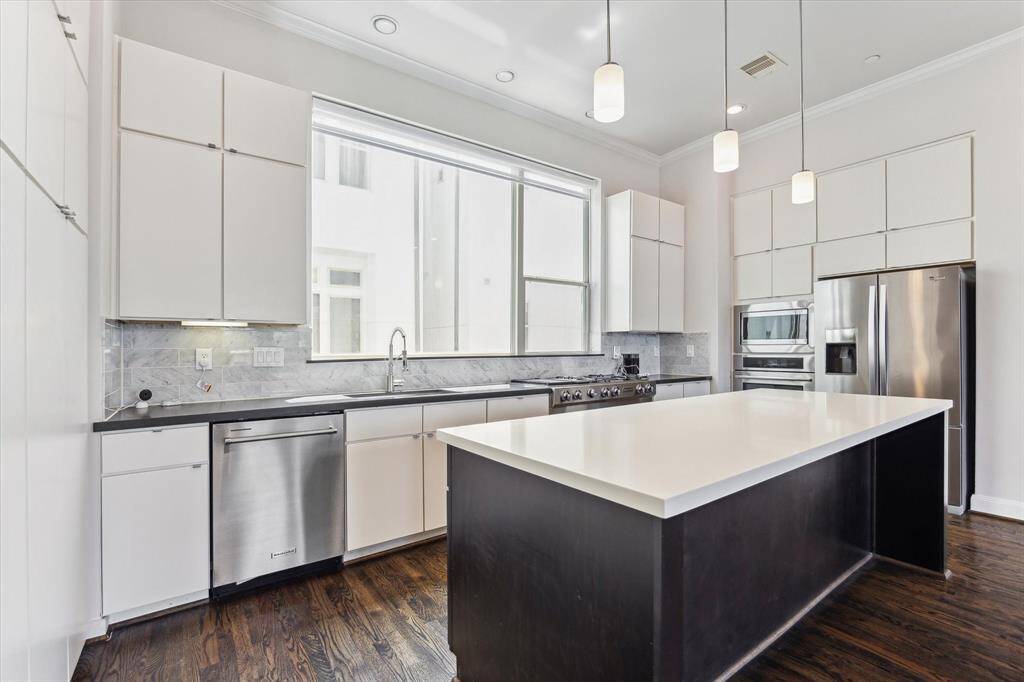 Modern kitchen featuring neutral tones throughout, creating a timeless and inviting space for cooking and entertaining.