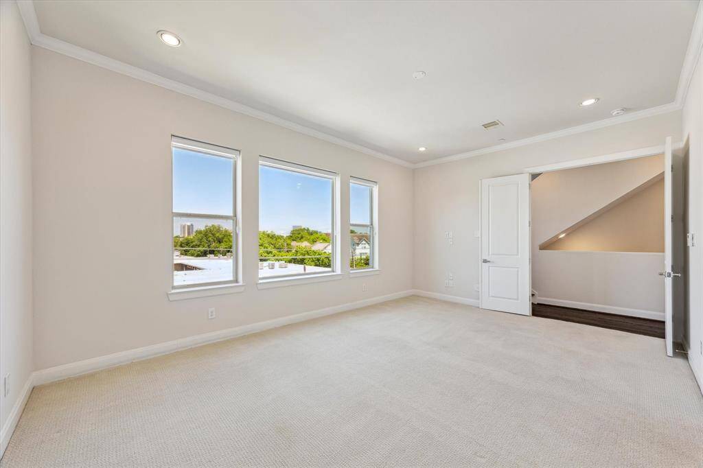 Primary bedroom with large windows that fill the room with natural daylight, creating a bright and airy retreat