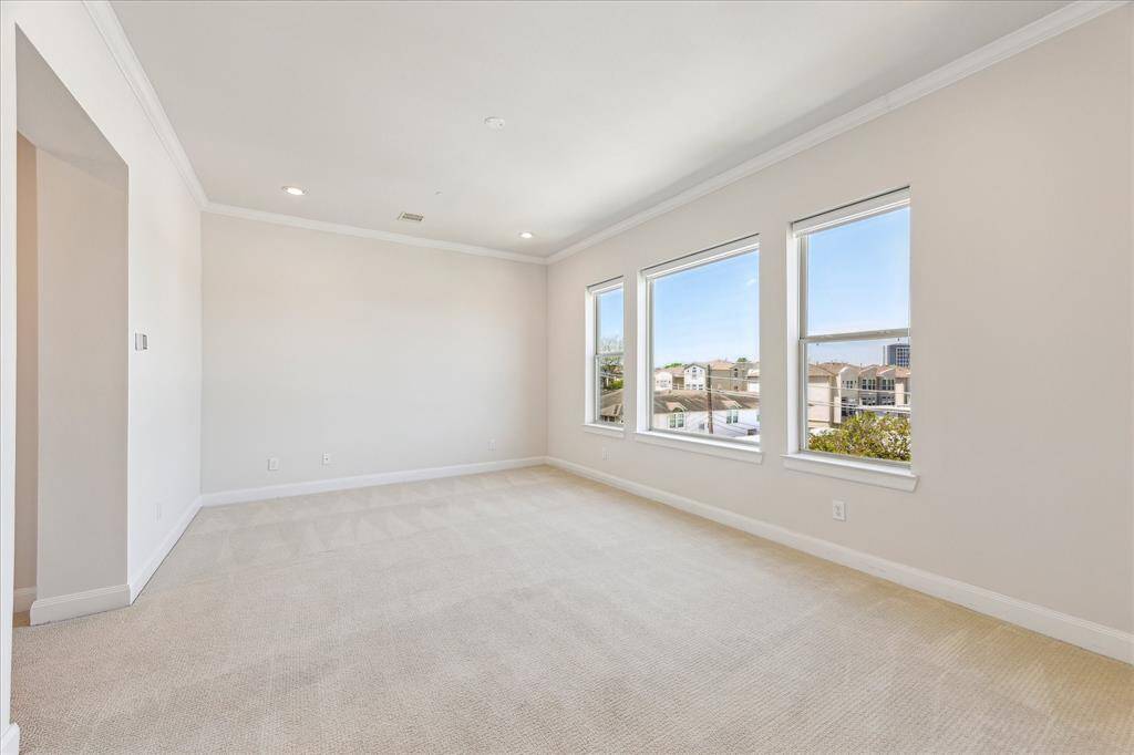 Primary bedroom with large windows that fill the room with natural daylight, creating a bright and airy retreat