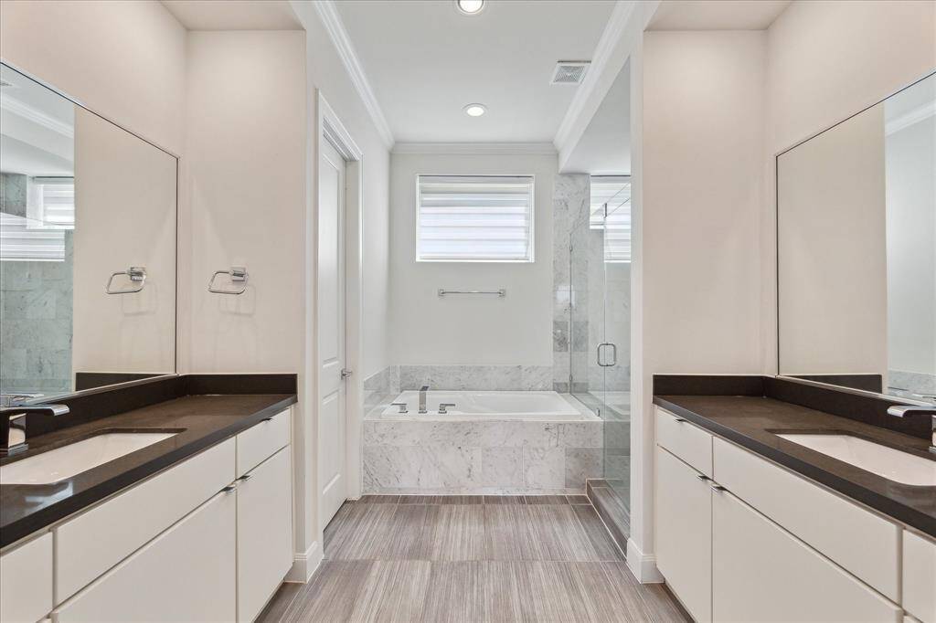 Primary bathroom featuring double sinks, offering ample space and functionality for your daily routine.