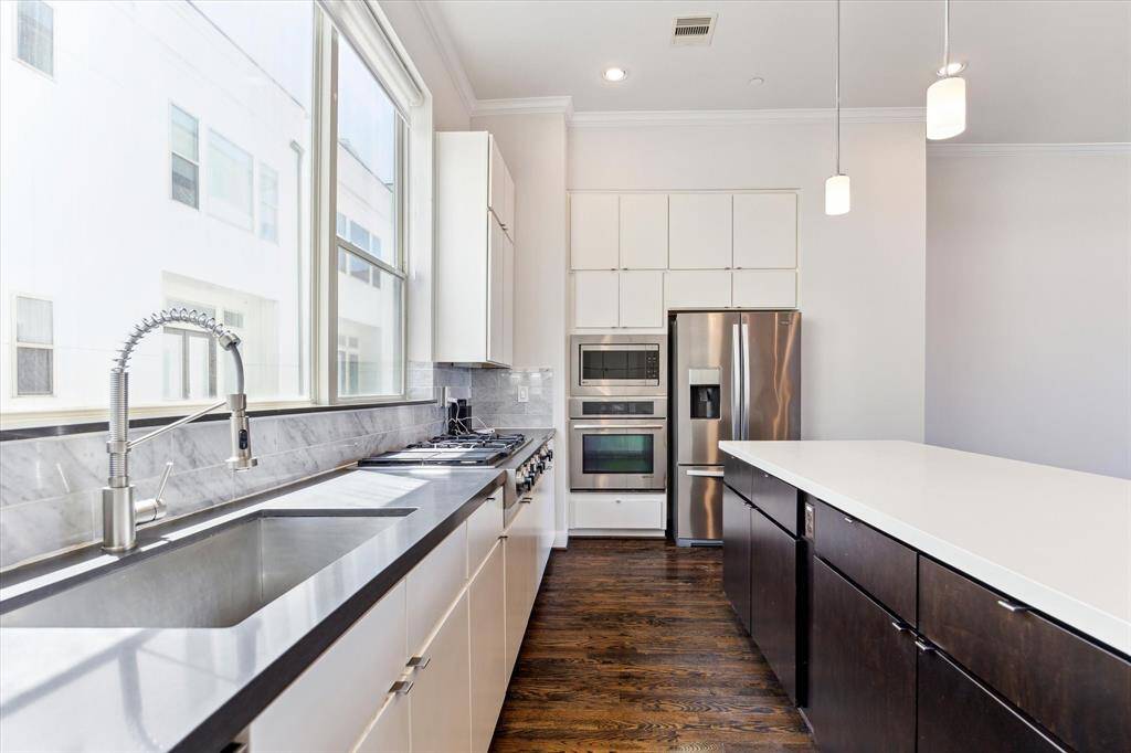 Modern kitchen flooded with natural light, creating a bright and inviting space for cooking and entertaining