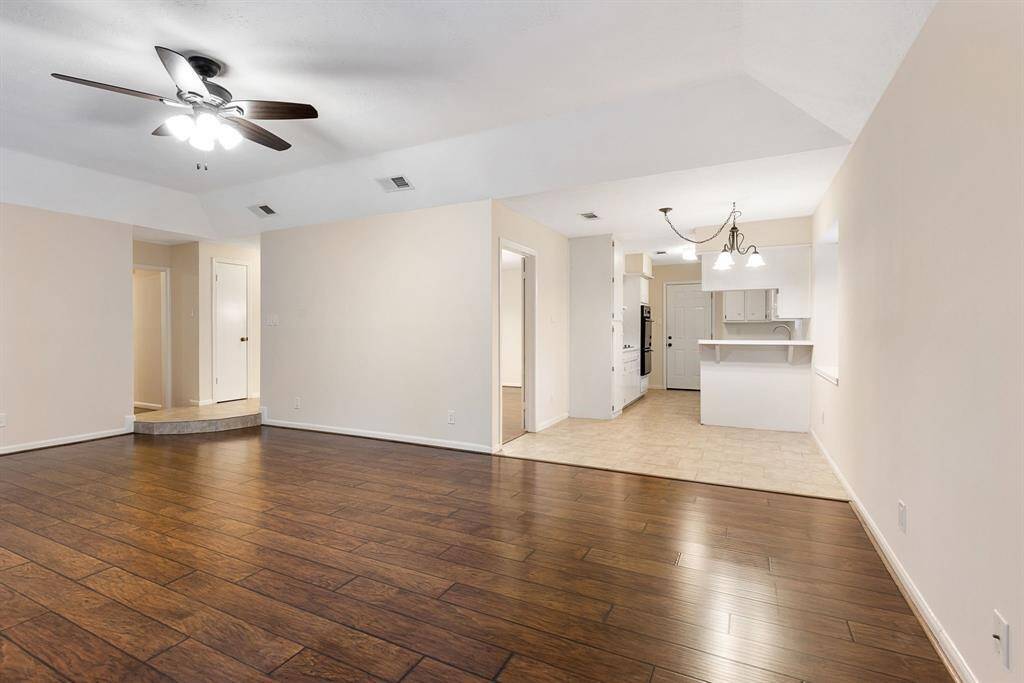 Living room view towards entry and kitchen