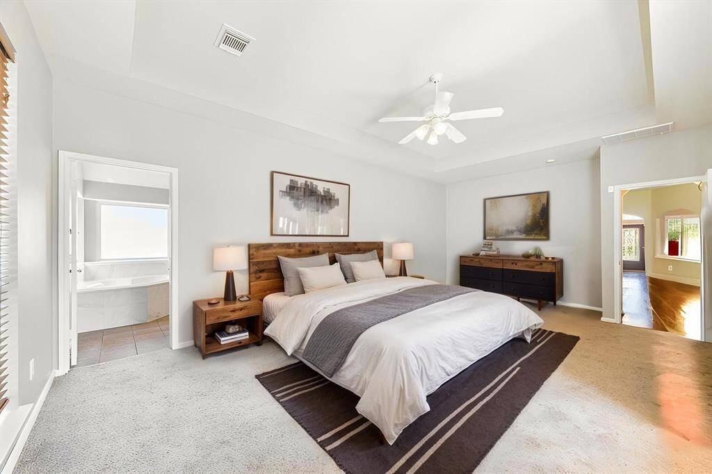 ENJOY EASY ACCESS TO THE EN-SUITE BATH. **This room has been virtually staged.