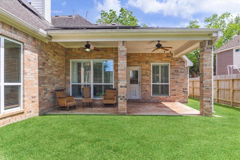 PEACEFUL BACKYARD OASIS WITH COVERED PATIO, PERFECT FOR RELAXING OR ENTERTAINING.