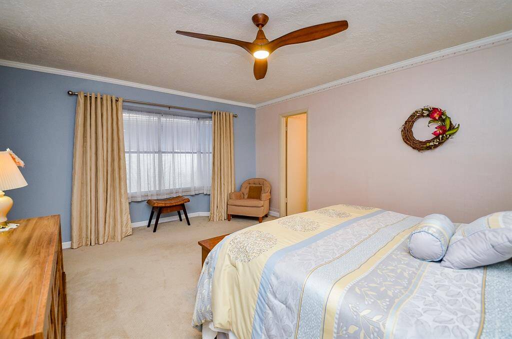 The wall of  windows in the primary bedrooms allows for natural light.