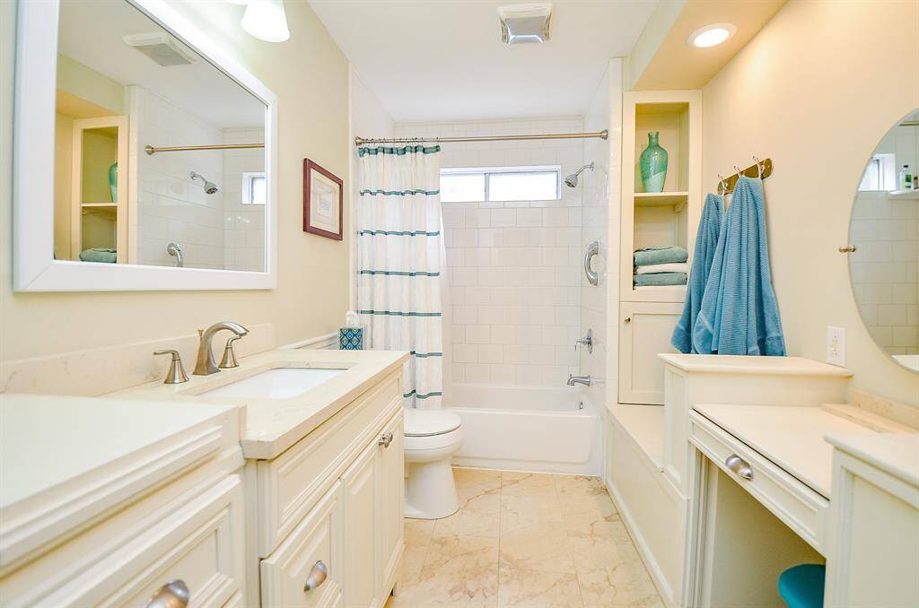Second full bath with custom cabinet and vanity area.