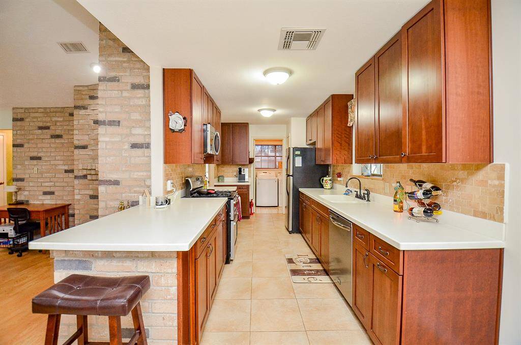 Great galley kitchen with neutral tile.
