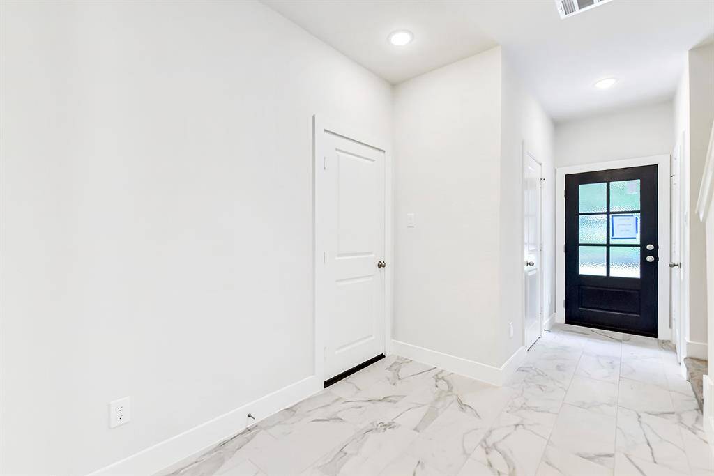 View looking back to your great front entry. Doors to left are half bathroom and doible car garaage.