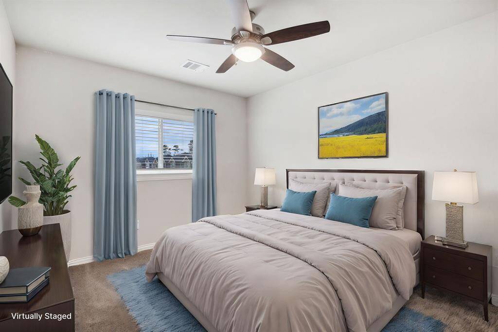 *Virtually Staged* Two secondary bedrooms, located on the opposite wing of the primary, each offer walk-in closets, providing plenty of storage