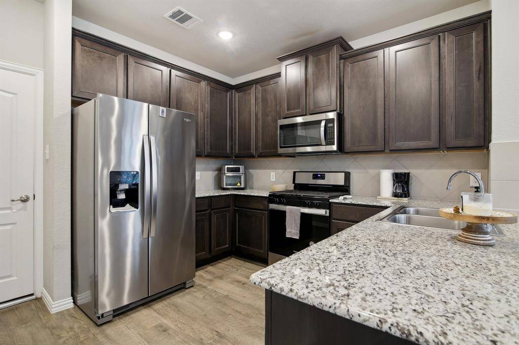 Featuring stainless steel appliances, with the refrigerator included for your convenience