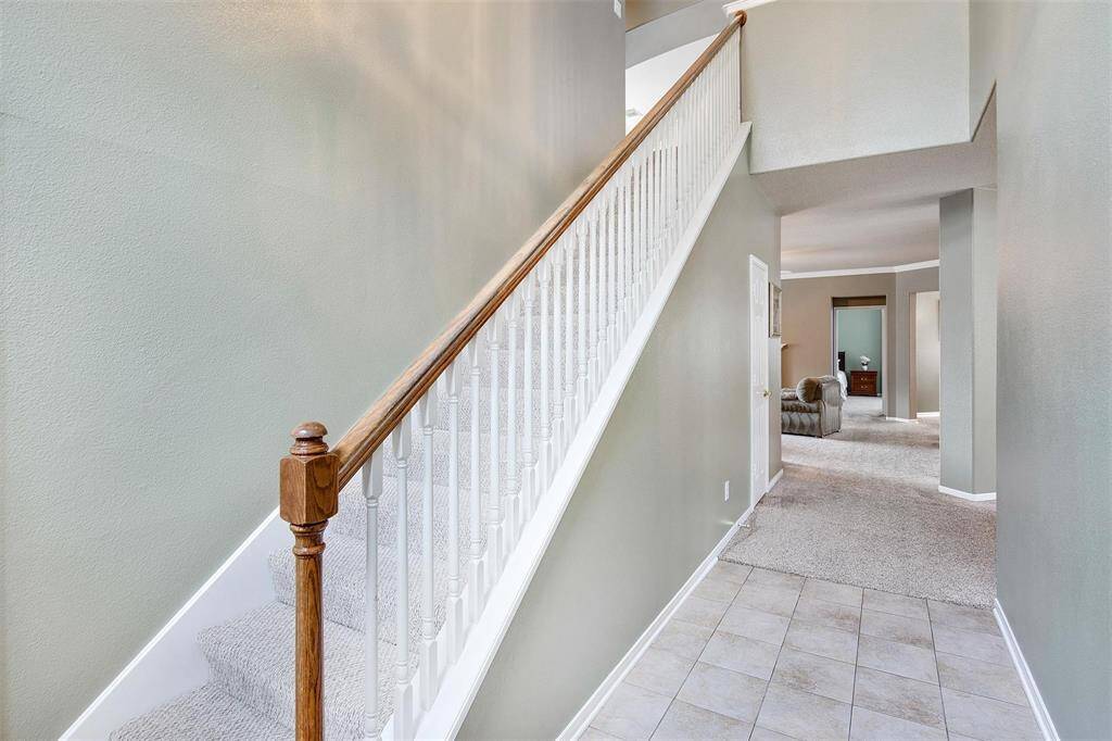 Stairway leading up to the second-floor rooms with a view of the entryway.