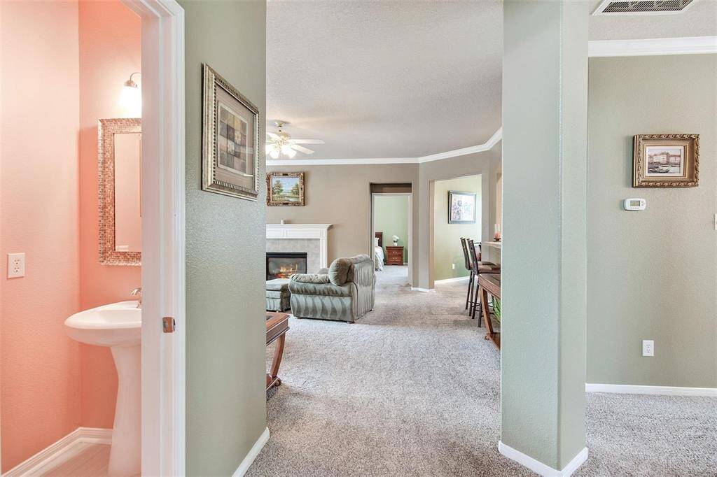 Another view of the entry way leading to the family room with a view of the powder room.