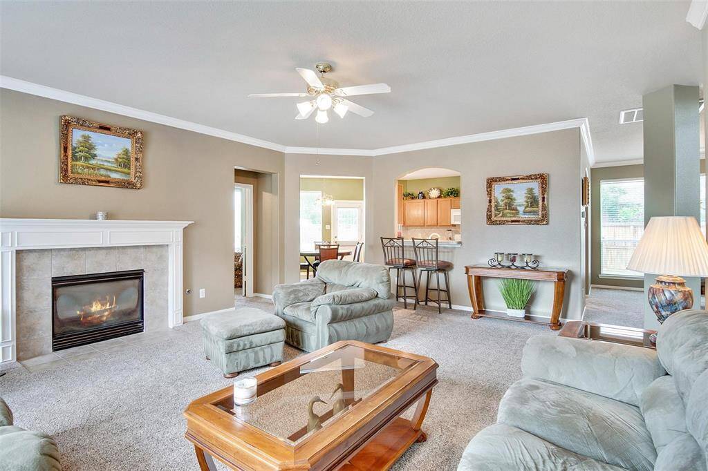 Step into the inviting living area, featuring a cozy fireplace and seamless flow into the dining space.