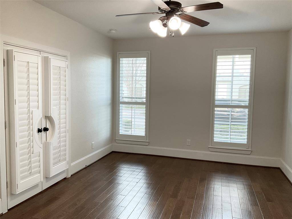Your 1st floor flex room is bright with hardwood floors, two tall windows with shutters, a ceiling fan, and a closet with stylish double doors. Perfect for a cozy bedroom, office space or playroom.
