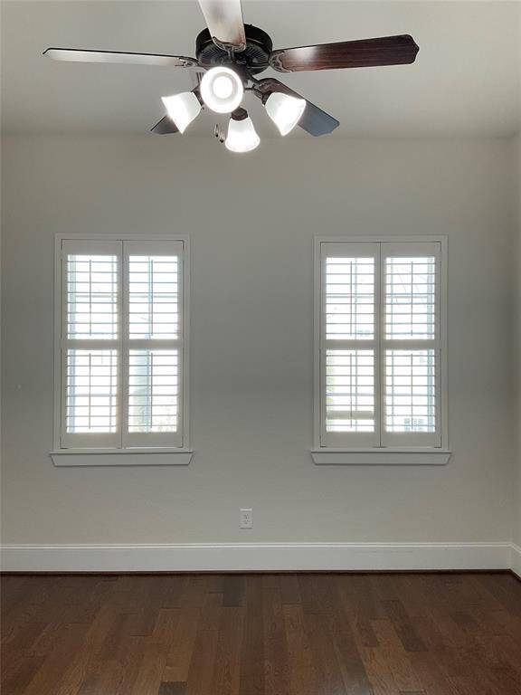 The secondary bed room features hardwood floors, ample natural light from two windows with shutters, a ceiling fan with lights, and an adjacent bathroom with a shower and tub combination.  The bedrooms are at separate ends of the hall offering space but not to far away.