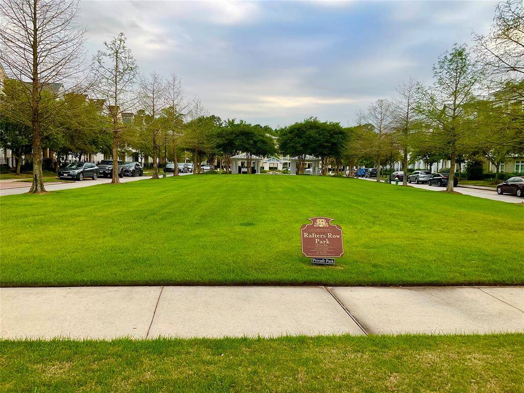 This photo showcases a serene neighborhood park with a wide, grassy area lined by trees. It's framed by quiet residential streets, offering a peaceful community setting ideal for family activities and relaxation.  Bring a picnic and meet your neighbors!