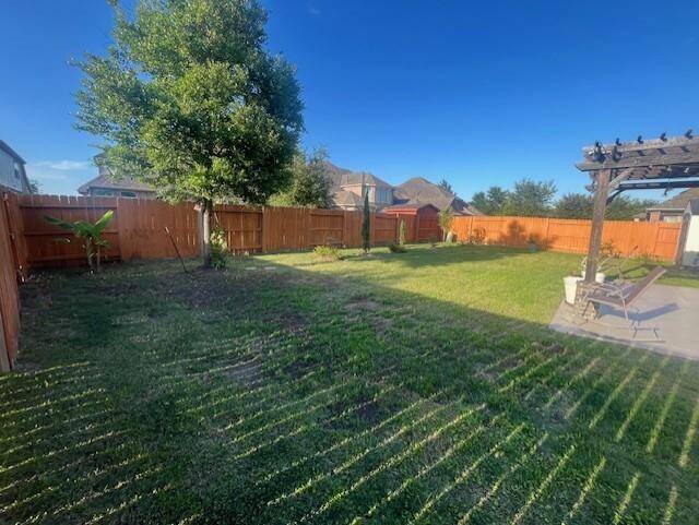 Spacious backyard retreat with ample green space, perfect for gardening, play, or entertaining. Enjoy the shade of a mature tree and the privacy of a fully fenced yard. A charming pergola creates a cozy outdoor seating area ideal for relaxing evenings or weekend gatherings. There's even space to customize with a pool, garden beds, or a playset—this backyard offers endless potential!
