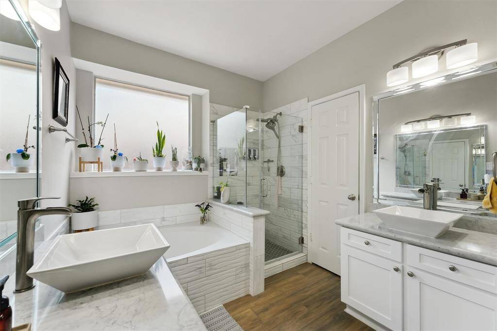 Primary ensuite with separate vanity spaces and updated shower and garden tub. Large walk in closet!