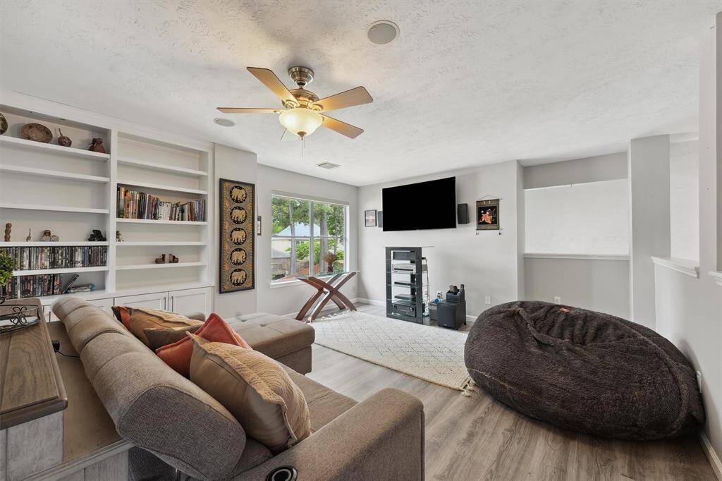 Upstairs family/media room equipped with built in speakers and custom book cases to sit and relax and enjoy some family time.