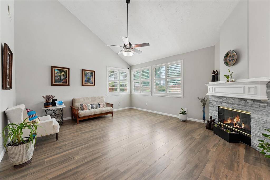 Large double height family room with gas log fireplace.