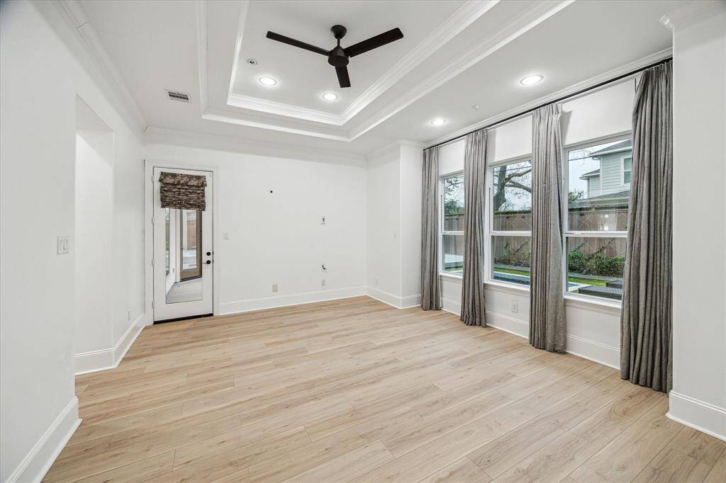 Spacious ground floor primary bedroom with views of the backyard.