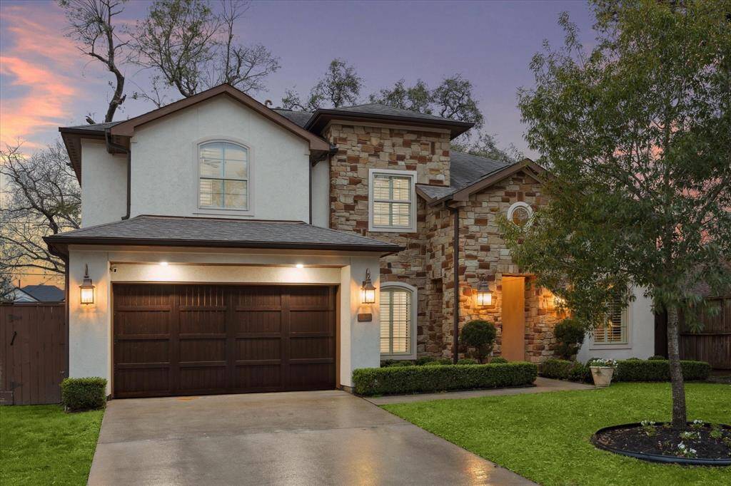 This beautiful two-story home features a mix of stone and stucco exterior, with a spacious double garage.