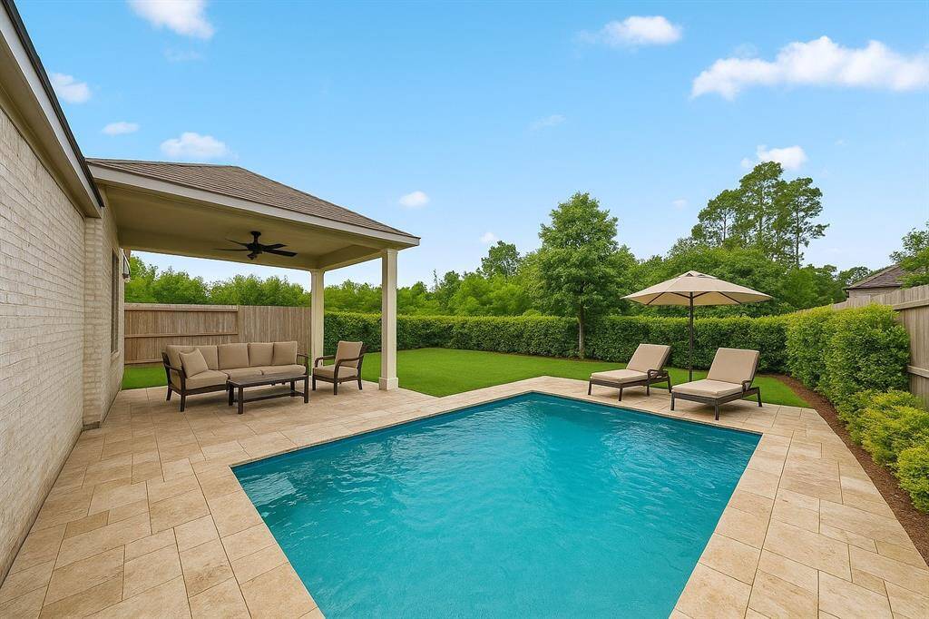Edited photo to show a rendering of a pool and covered patio.
