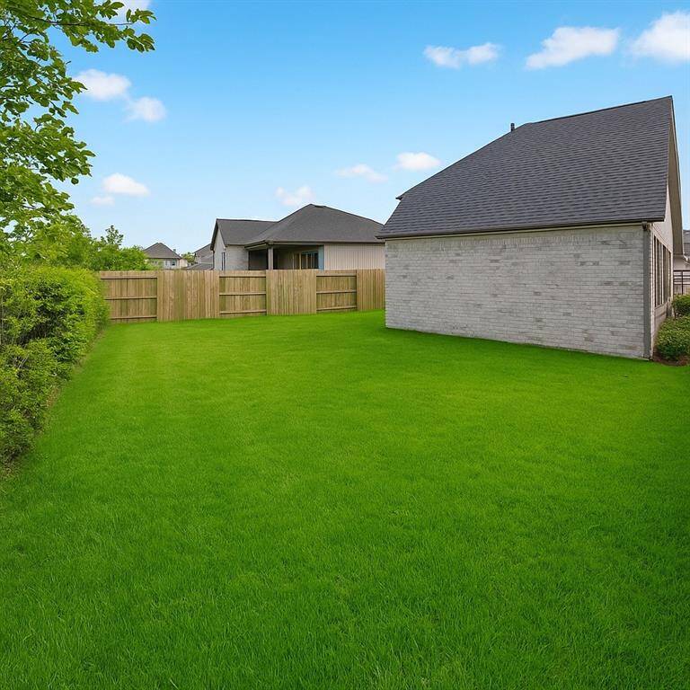 View from the back of the home edited to show green grass.
