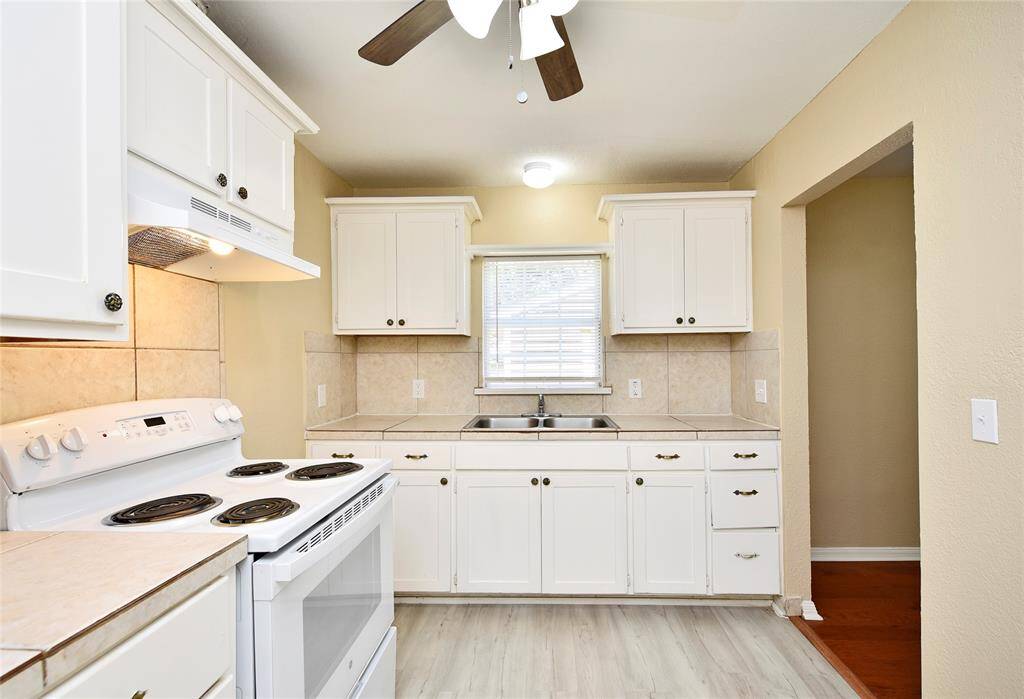 The kitchen has solid wood cabinets and is lite and bright.