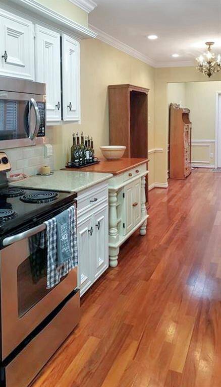 Gorgeous open kitchen with stainless appliances.